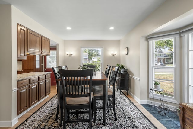 dining area featuring light wood-style flooring, baseboards, and recessed lighting