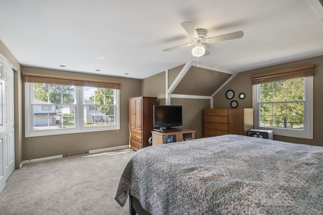 bedroom with lofted ceiling, multiple windows, visible vents, and carpet flooring