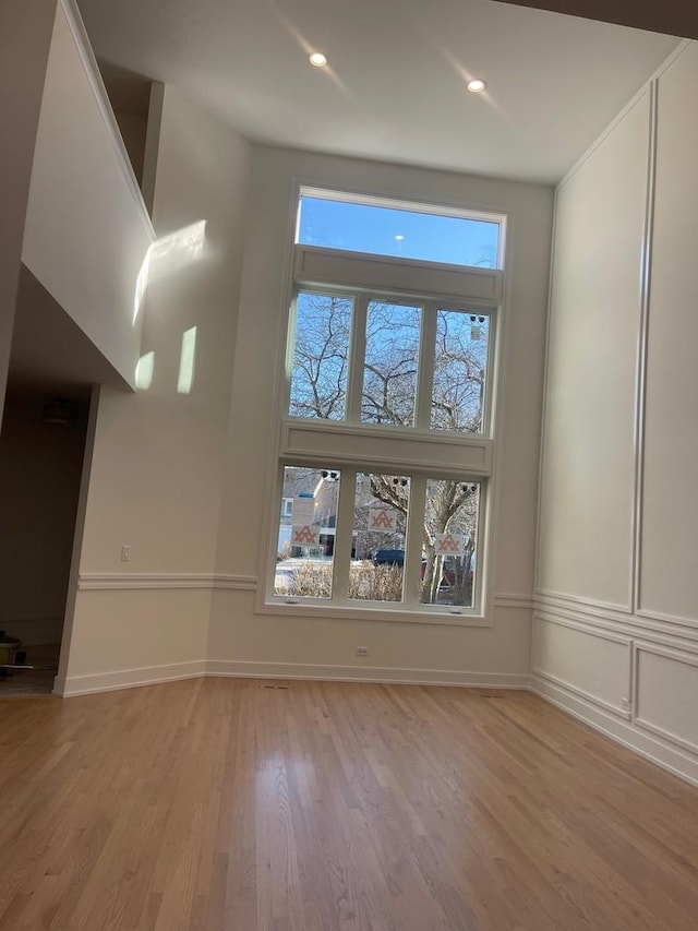 interior space featuring light wood finished floors, recessed lighting, and baseboards