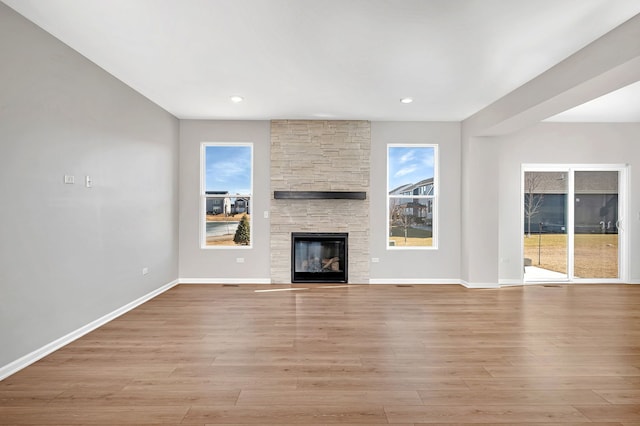 733 Juniper St, Oswego, IL 60543 - unfurnished living room featuring a stone fireplace, light wood-style flooring, and recessed lighting