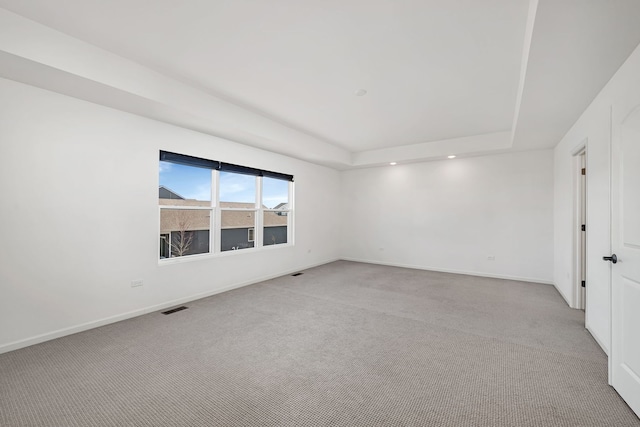 733 Juniper St, Oswego, IL 60543 - spare room with light carpet, a raised ceiling, and recessed lighting