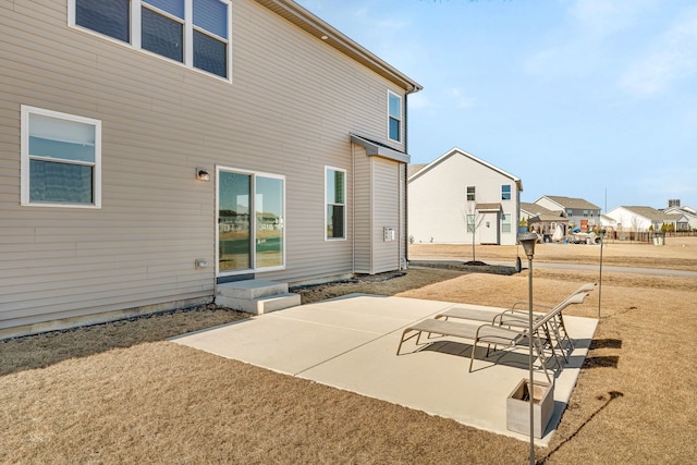 733 Juniper St, Oswego, IL 60543 - back of property with a patio area and a residential view