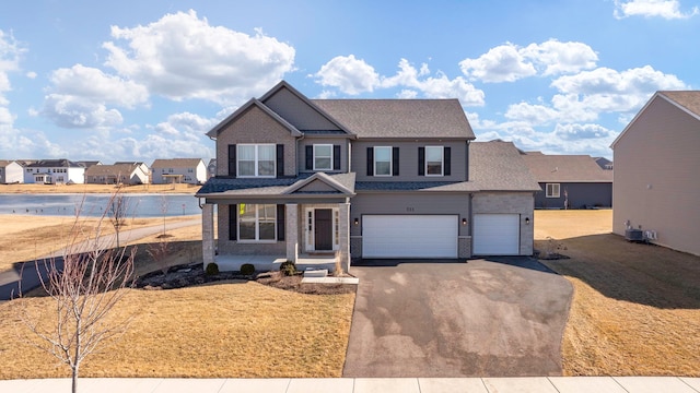 733 Juniper St, Oswego, IL 60543 - view of front facade with driveway, a porch, brick siding, a garage, and a residential view