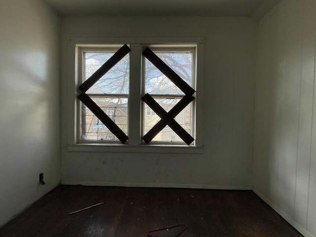 7310 S Kingston Ave, Chicago, IL 60649 - empty room featuring dark wood-style floors, baseboards, and a healthy amount of sunlight