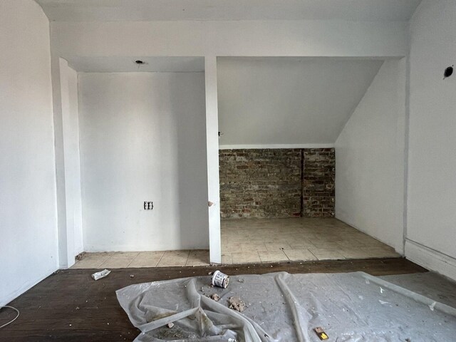 7310 S Kingston Ave, Chicago, IL 60649 - additional living space with vaulted ceiling and brick wall