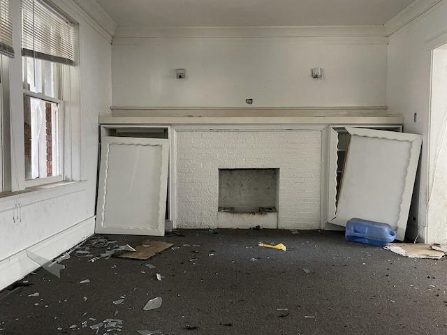 7310 S Kingston Ave, Chicago, IL 60649 - unfurnished living room with a brick fireplace, a healthy amount of sunlight, and crown molding