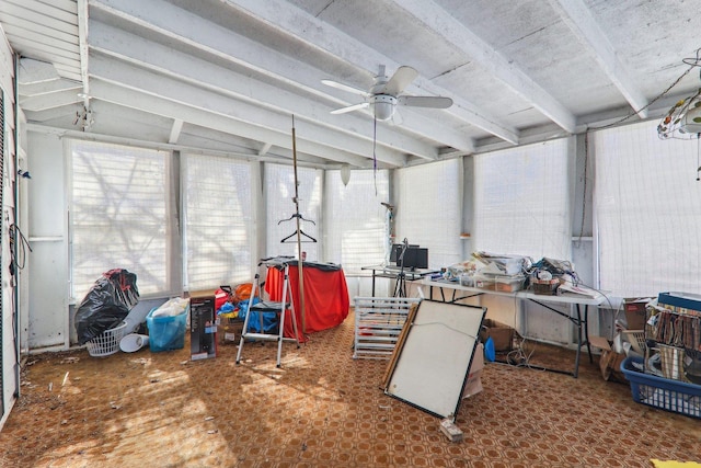 sunroom featuring beamed ceiling and a ceiling fan