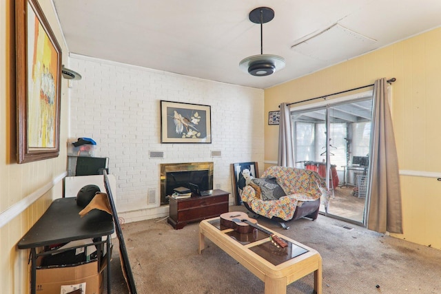 living area featuring carpet floors, a brick fireplace, visible vents, and brick wall