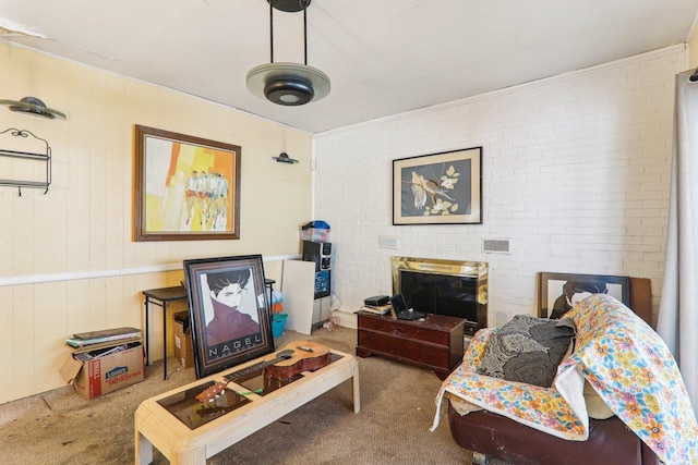 living room with carpet floors and brick wall