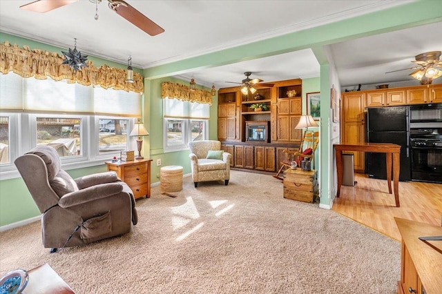 interior space featuring baseboards, a ceiling fan, and crown molding