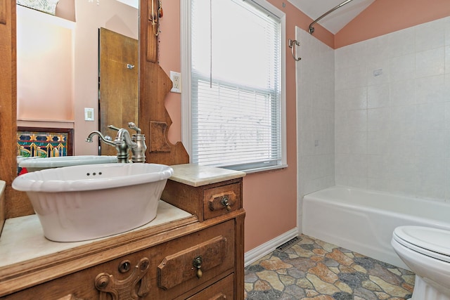 full bath with shower / bath combination, baseboards, toilet, lofted ceiling, and vanity