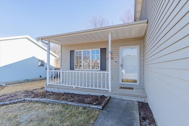 view of exterior entry featuring covered porch