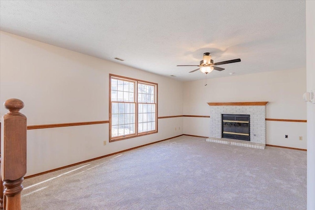 unfurnished living room featuring carpet, visible vents, a brick fireplace, a textured ceiling, and baseboards