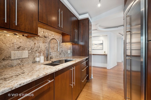 474 N Lake Shore Dr Unit 4810, Chicago, IL 60611 - kitchen with decorative backsplash, high quality fridge, a sink, light wood-style floors, and light stone counters