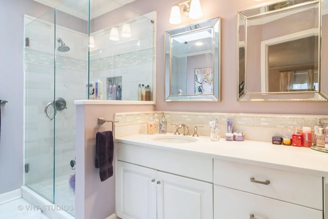 full bathroom featuring decorative backsplash, vanity, and a stall shower