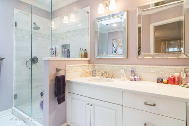 full bathroom with a shower stall, tasteful backsplash, and vanity