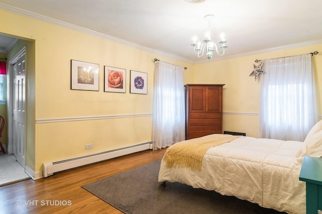 bedroom featuring a baseboard radiator, wood finished floors, ornamental molding, and an inviting chandelier