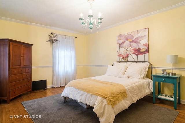 bedroom with wood finished floors, a chandelier, and crown molding