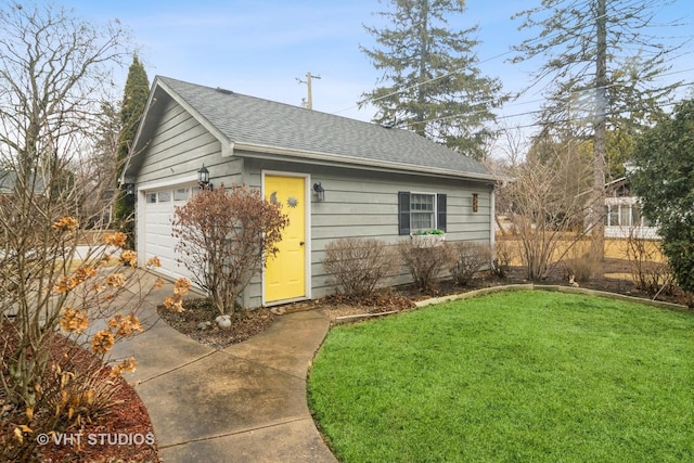 ranch-style home with a garage, a front lawn, and roof with shingles