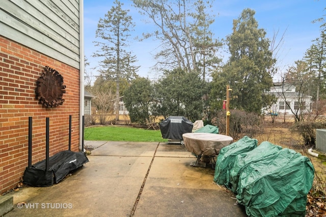 view of patio / terrace featuring a grill and fence