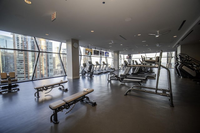 gym with a wealth of natural light, expansive windows, and visible vents