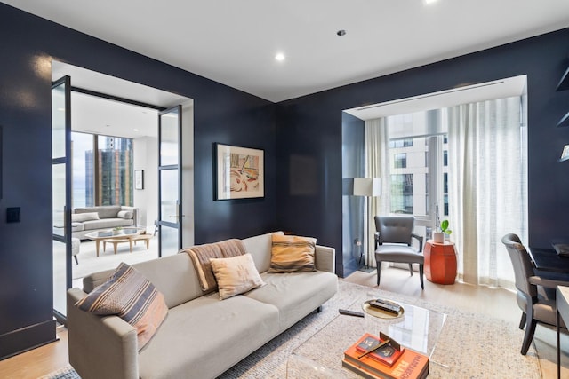 living area featuring recessed lighting, a wealth of natural light, and wood finished floors