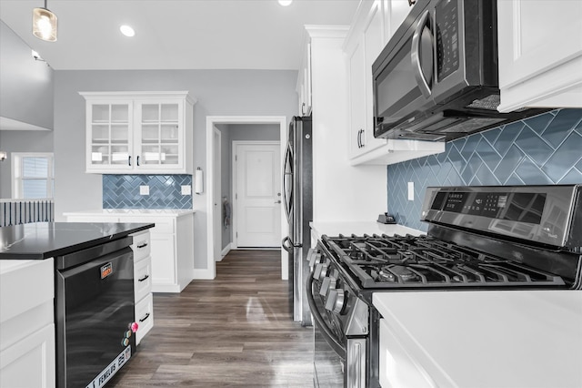 kitchen featuring dark wood finished floors, decorative backsplash, white cabinets, glass insert cabinets, and appliances with stainless steel finishes