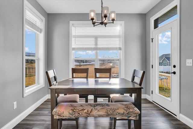 dining room with baseboards, dark wood-type flooring, and an inviting chandelier