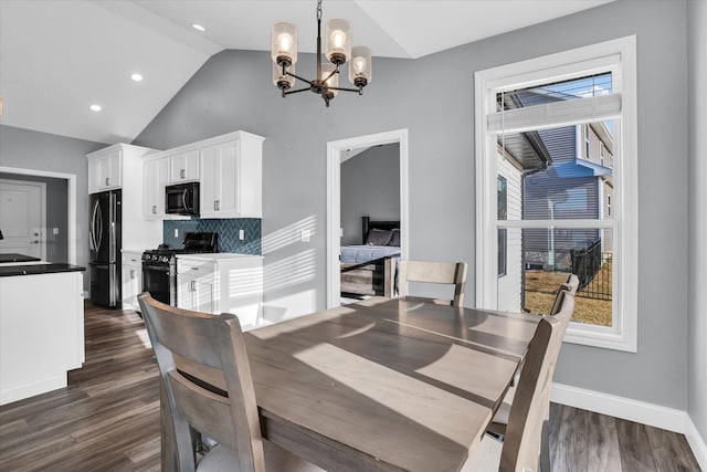 dining space featuring a wealth of natural light, lofted ceiling, and dark wood-type flooring