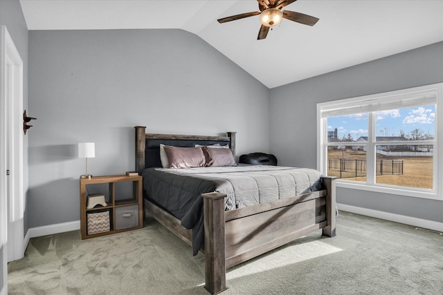 carpeted bedroom with visible vents, a ceiling fan, baseboards, and vaulted ceiling