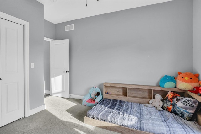 carpeted bedroom featuring visible vents and baseboards