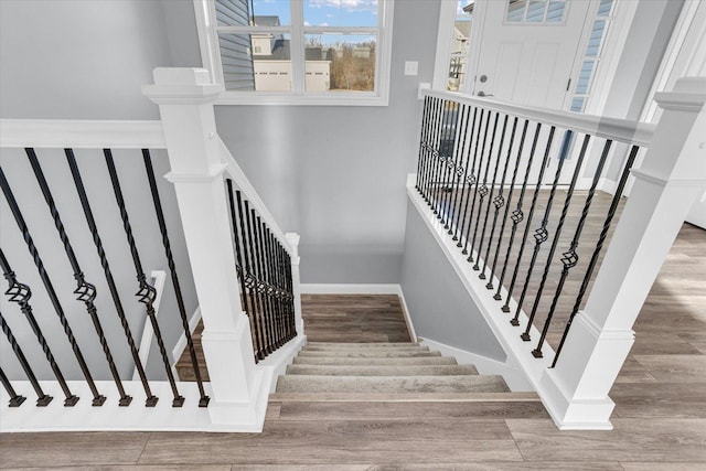 stairs with baseboards and wood finished floors