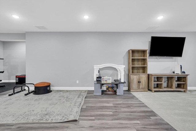 interior space with recessed lighting, baseboards, and wood finished floors