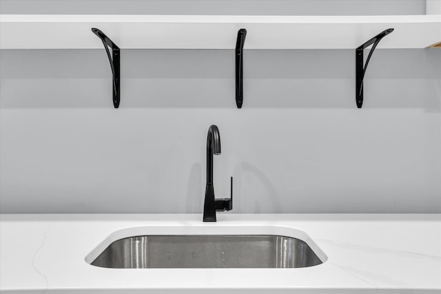 interior details with light countertops and a sink