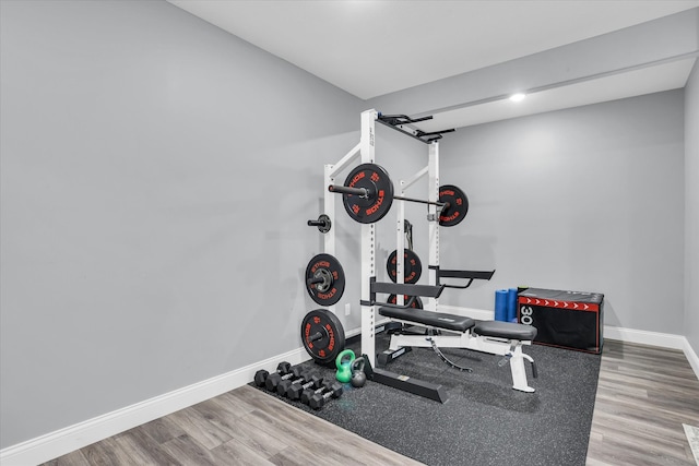 workout room with wood finished floors and baseboards