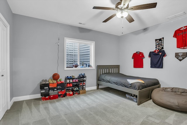 carpeted bedroom with baseboards, visible vents, and ceiling fan