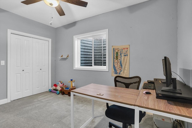 home office featuring light colored carpet and a ceiling fan