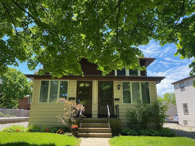 view of front of house featuring fence