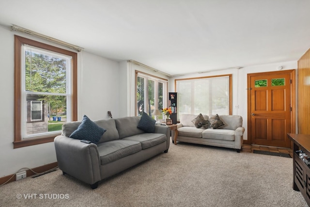 living room featuring carpet flooring and a healthy amount of sunlight