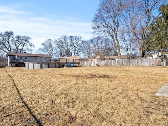 view of yard with fence and a fenced in pool