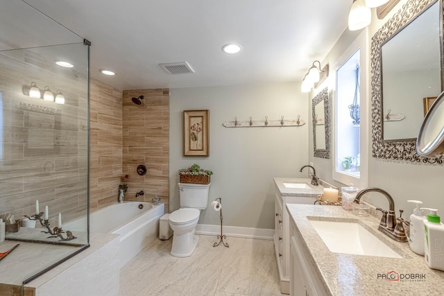 full bath featuring toilet, double vanity, visible vents, and a sink