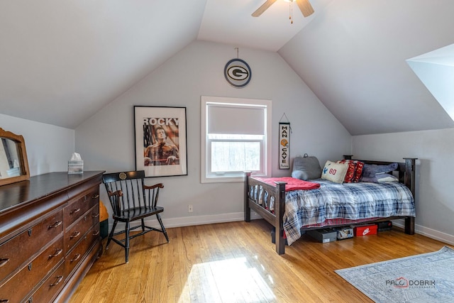 bedroom with lofted ceiling, light wood-style floors, baseboards, and a ceiling fan