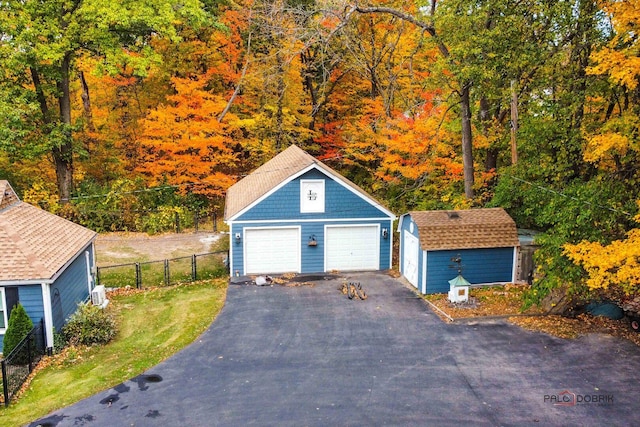 detached garage featuring fence