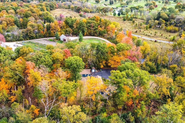 birds eye view of property featuring a view of trees