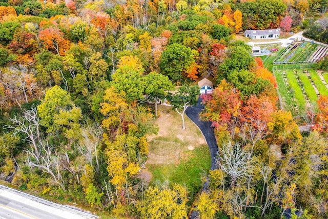 drone / aerial view featuring a wooded view