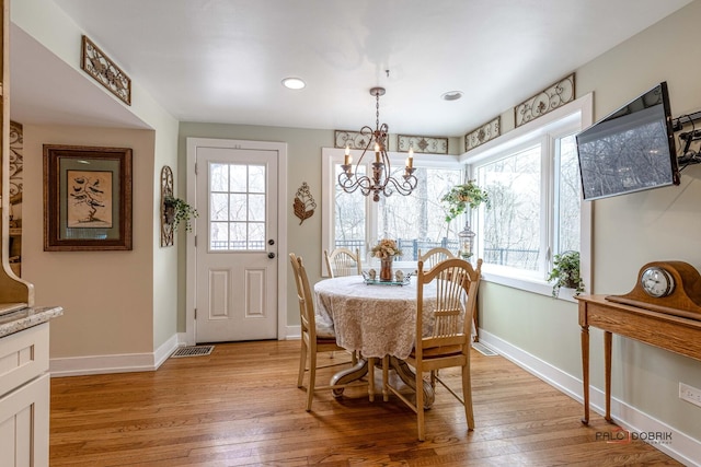 dining space featuring baseboards, visible vents, and light wood-style floors