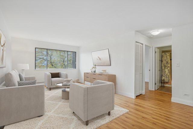 living room featuring light wood-style flooring and baseboards