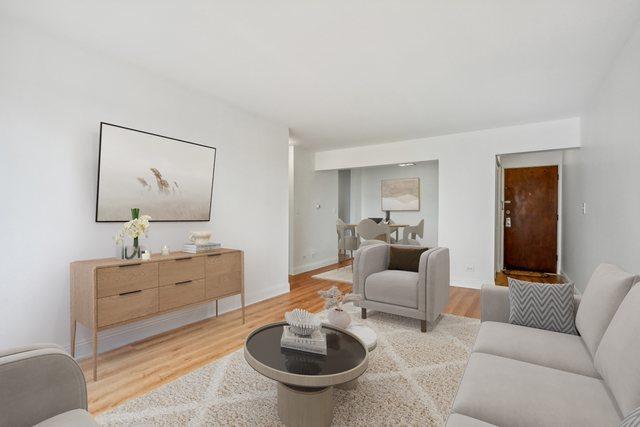 living room with light wood-type flooring and baseboards