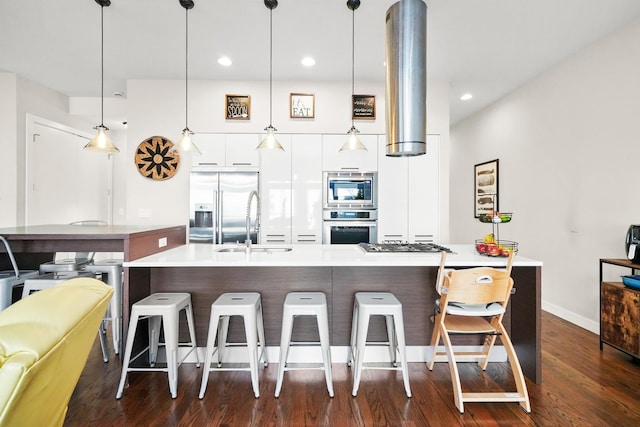 kitchen featuring built in appliances, a breakfast bar, dark wood-style flooring, white cabinets, and modern cabinets