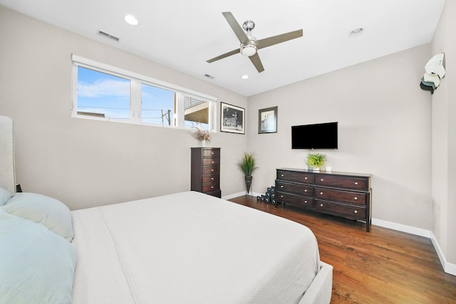 bedroom with baseboards, visible vents, wood finished floors, and recessed lighting